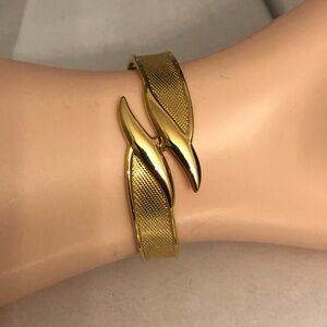 Designer gold tone clamper bangle Monet